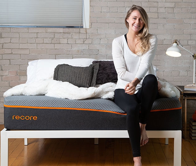 The best mattress in Canada page on www.themattressbuyerguide.com, showing a model sitting on the edge of The Recore Mattress