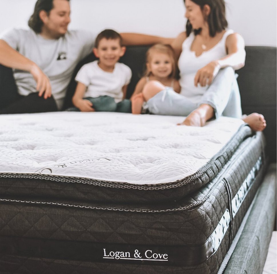 Family sitting on the mattress.