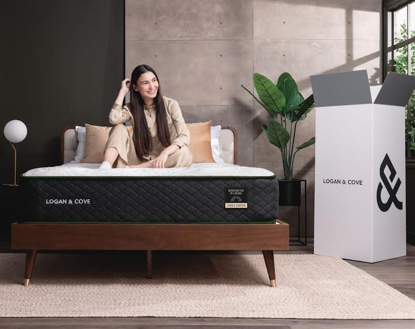 <div id="logan"> </div>
View from the foot of the Logan And Cove Mattress showing its thick pillow top, the diamond pattern on the exterior sides, and the delivery box sitting next to the mattress. the delivery box is about 42" tall and 20" wide all the way around.
